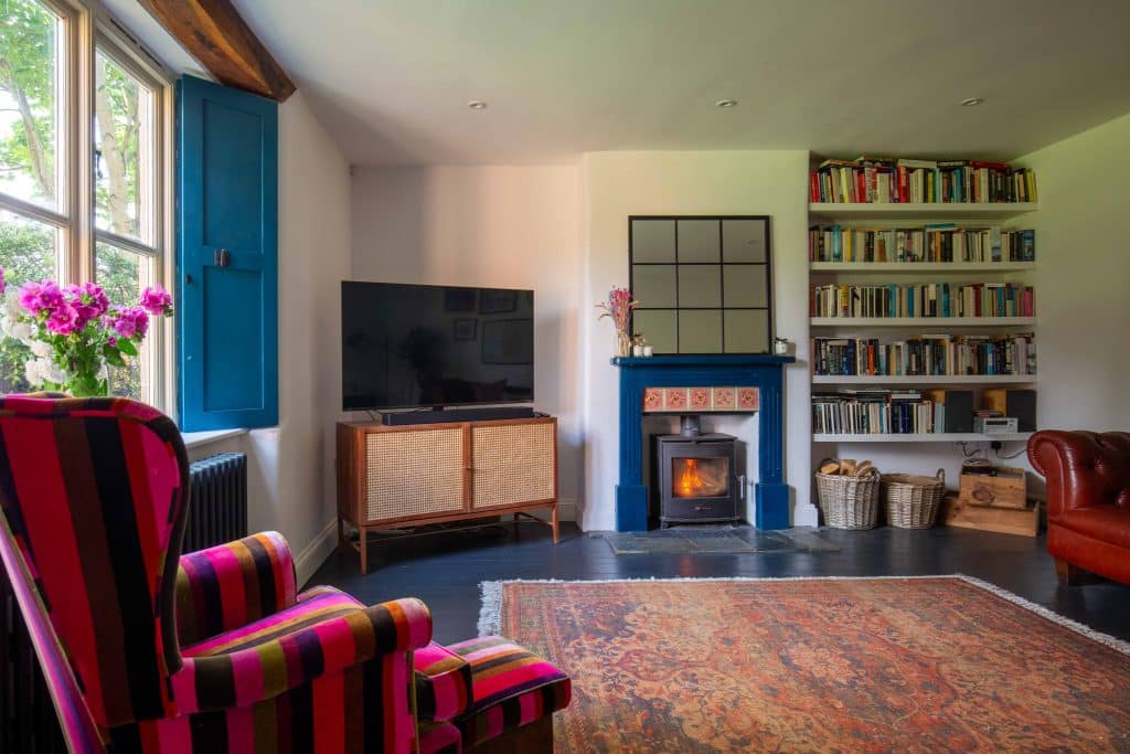 a living room filled with furniture and a fire place