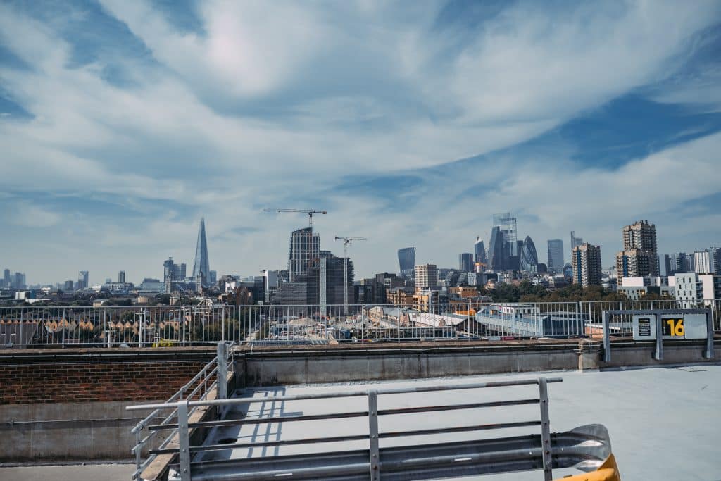 a bridge over a body of water with a city in the background