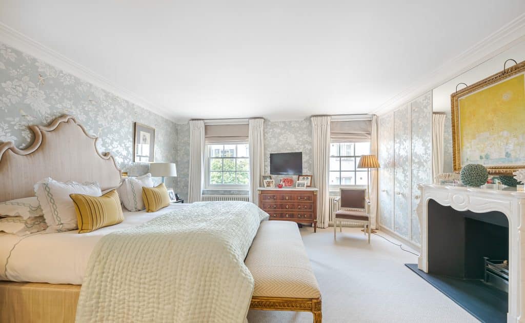 a living room with a bed and a fireplace