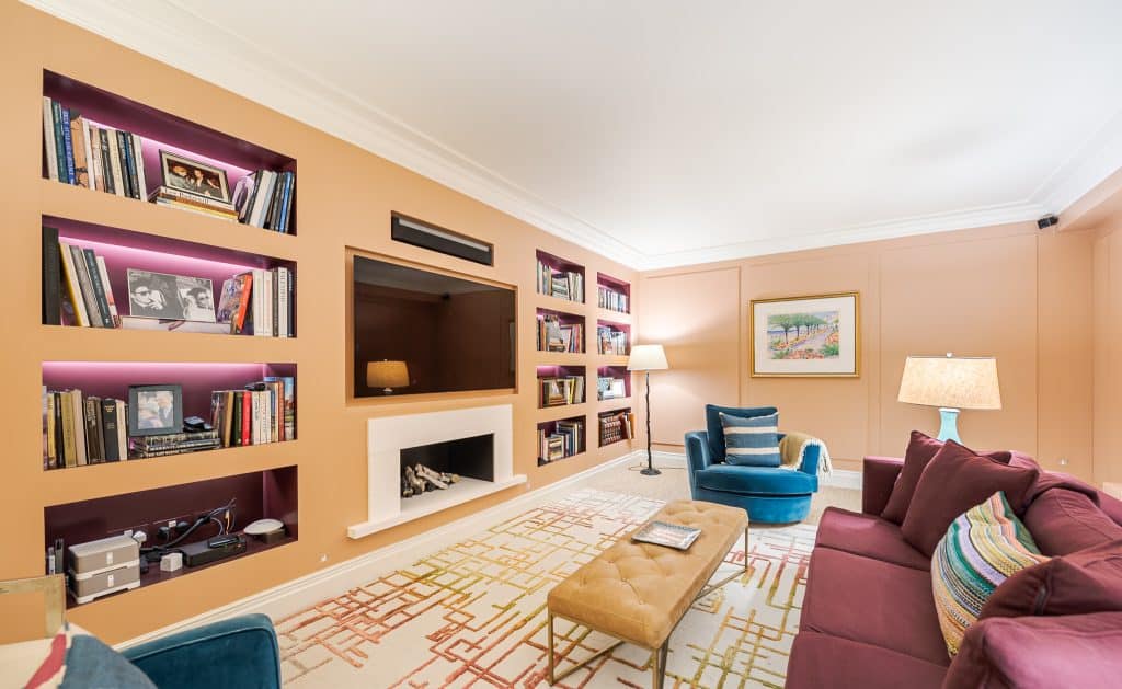 a living room filled with furniture and a book shelf