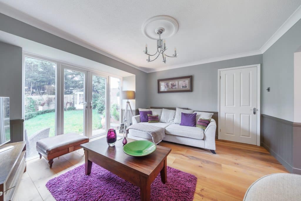 a living room filled with furniture and a large window