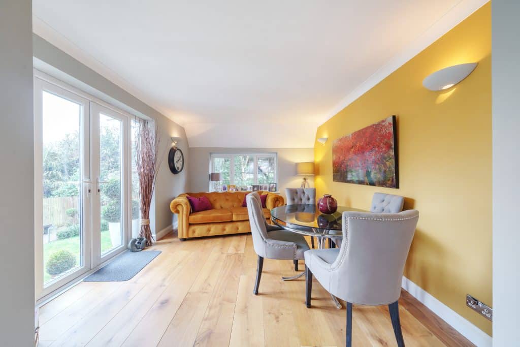 a living room filled with furniture and a large window