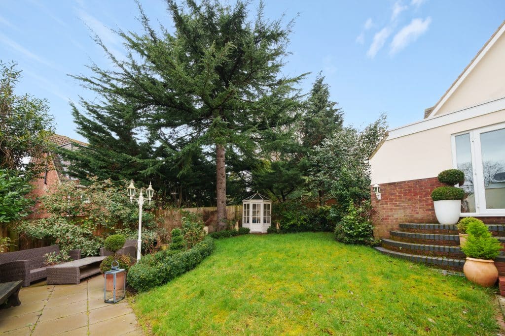 a garden in front of a brick building