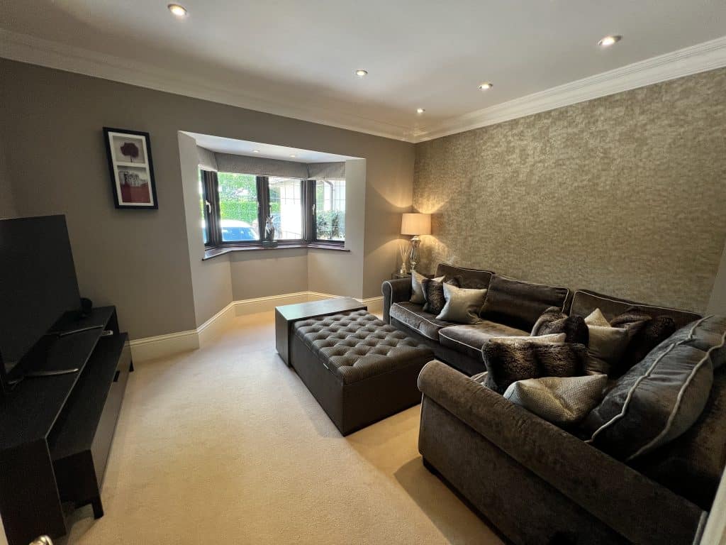 a living room filled with furniture and a flat screen tv