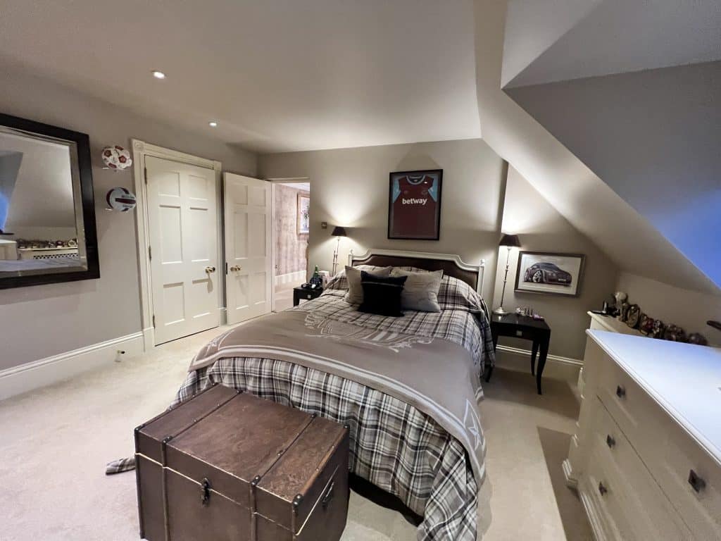 a bedroom with a large bed in a room