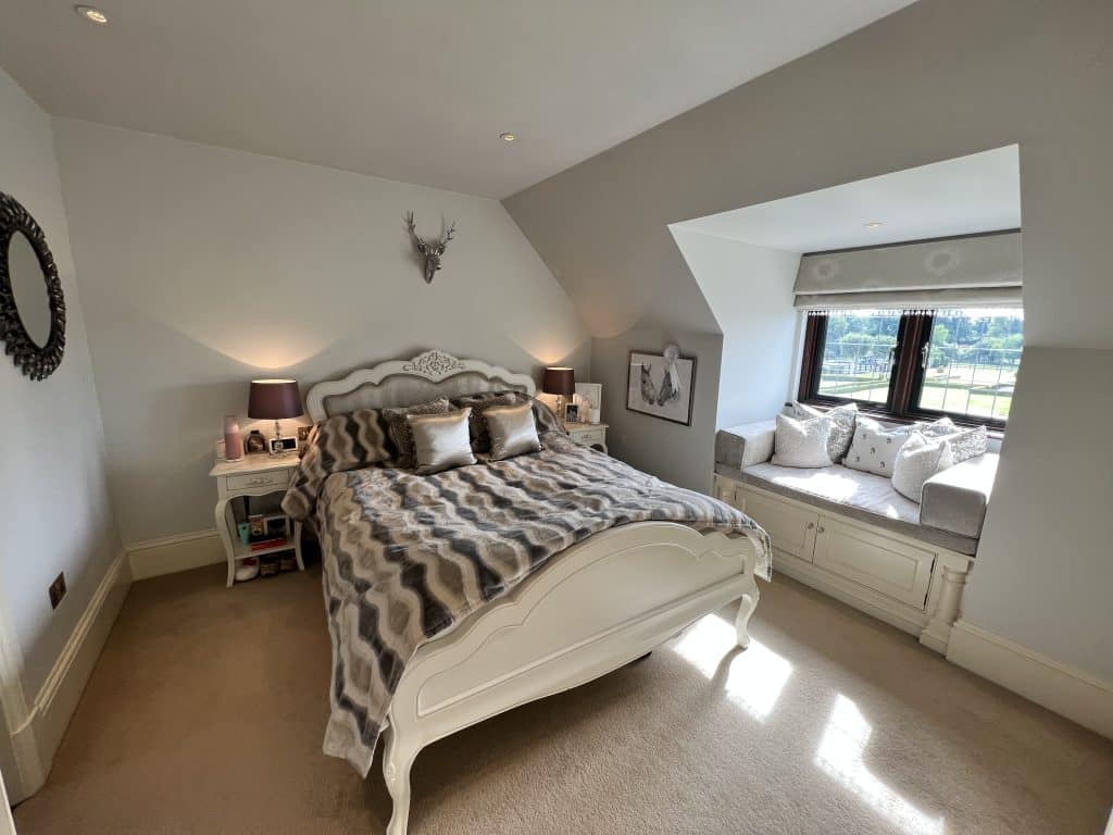 a bedroom with a bed and desk in a room