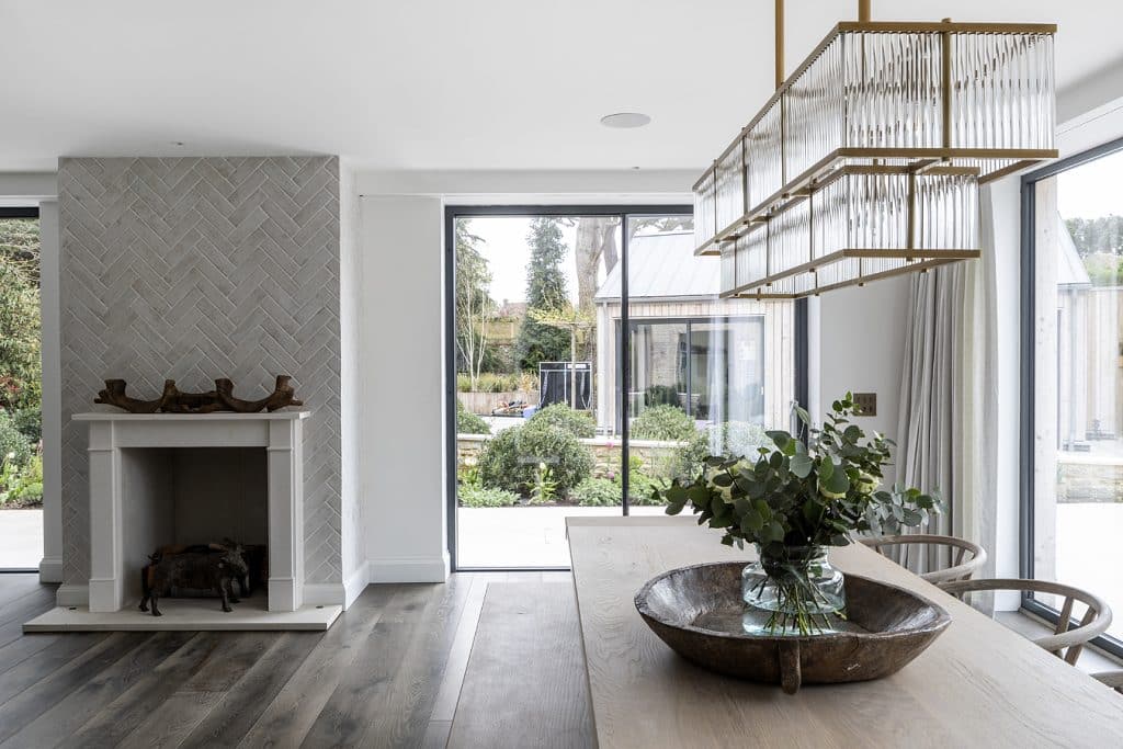 a room filled with furniture and vase of flowers next to a window