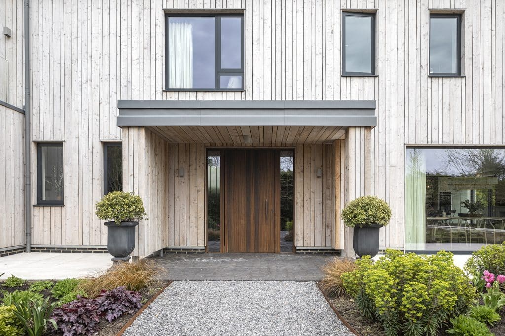 a house with bushes in front of a building