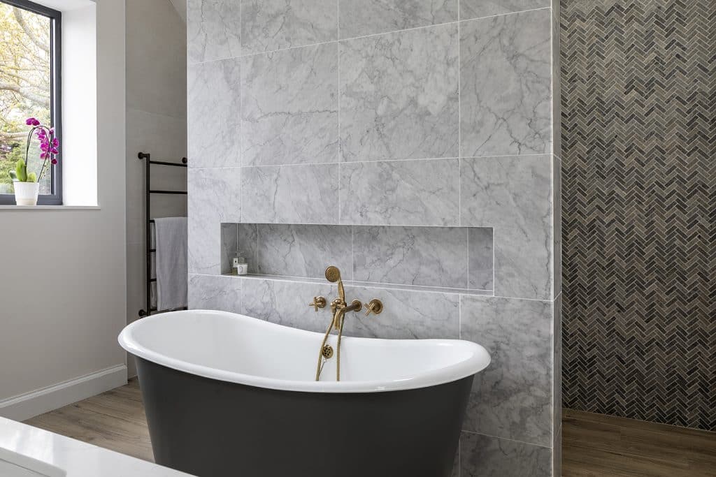 a large tub next to a sink