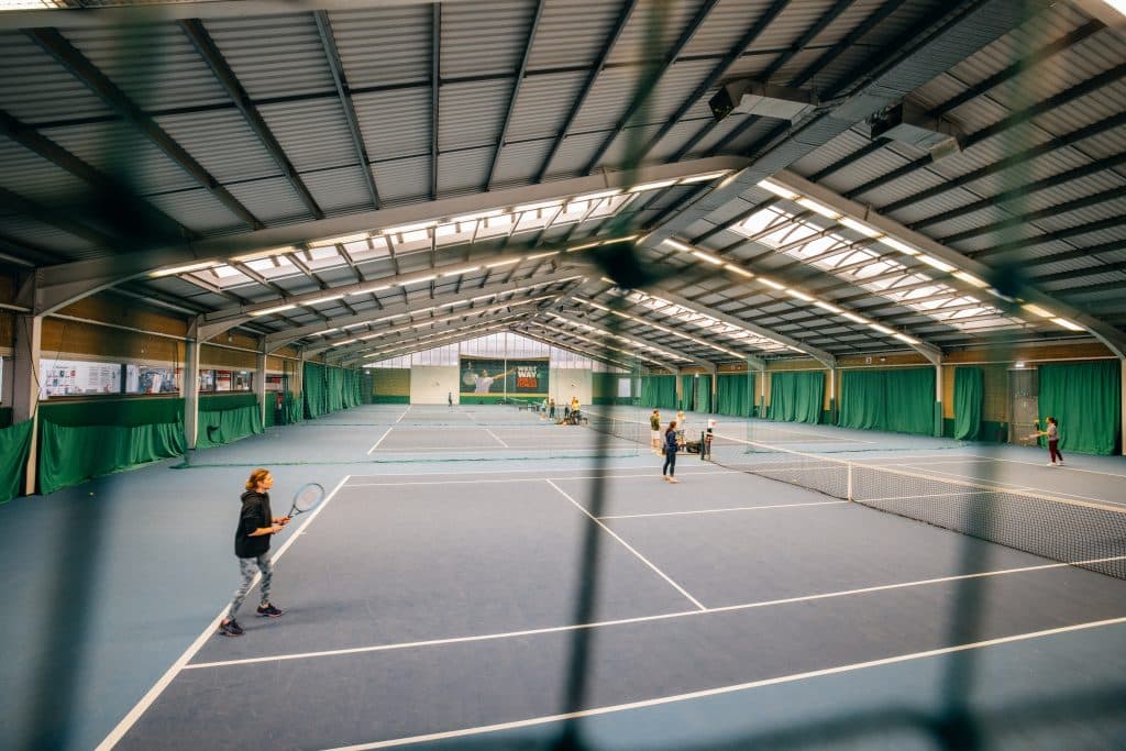 a group of people walking on the court
