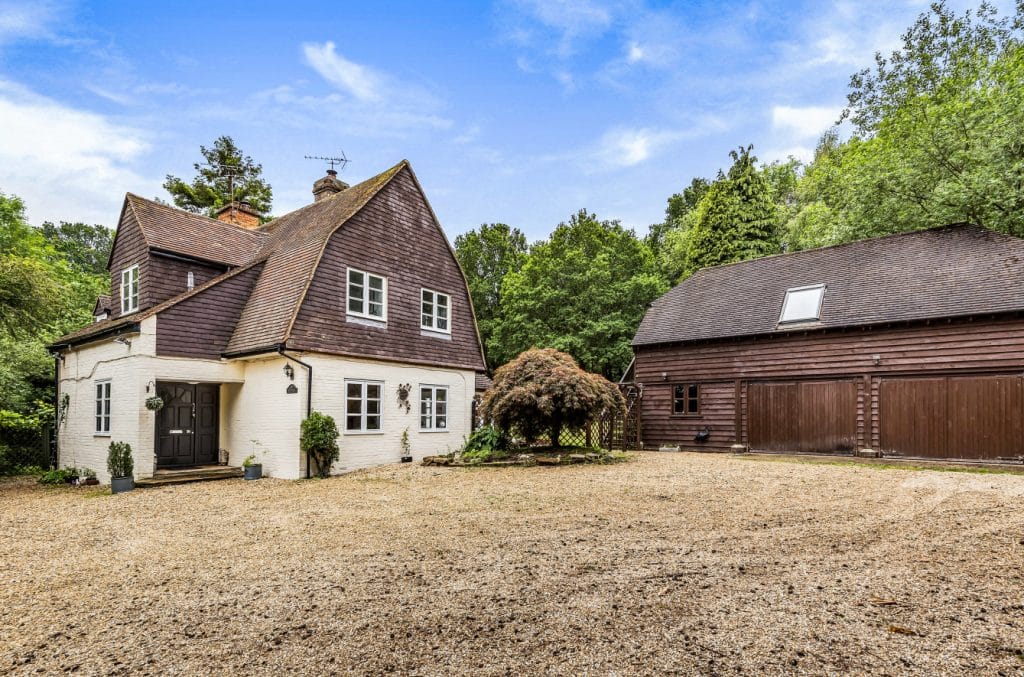 an old brick house with trees in the background