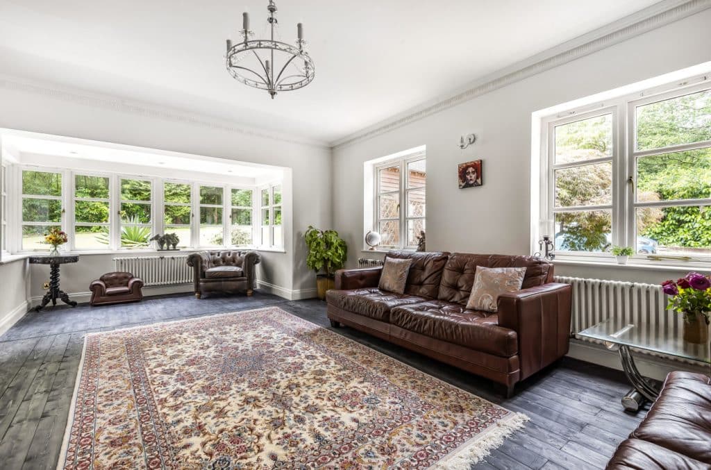 a living room filled with furniture and a large window