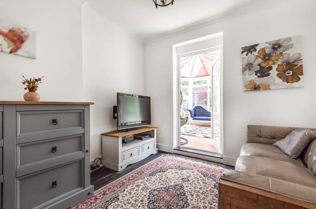 a bedroom with a bed and a mirror in a room