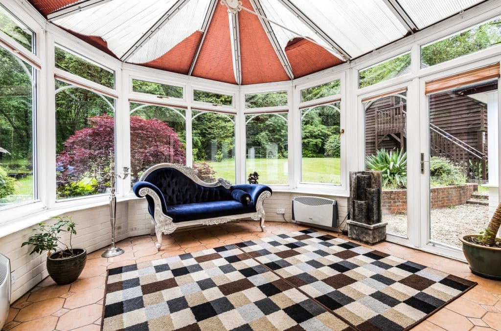 a living room filled with furniture and a large window