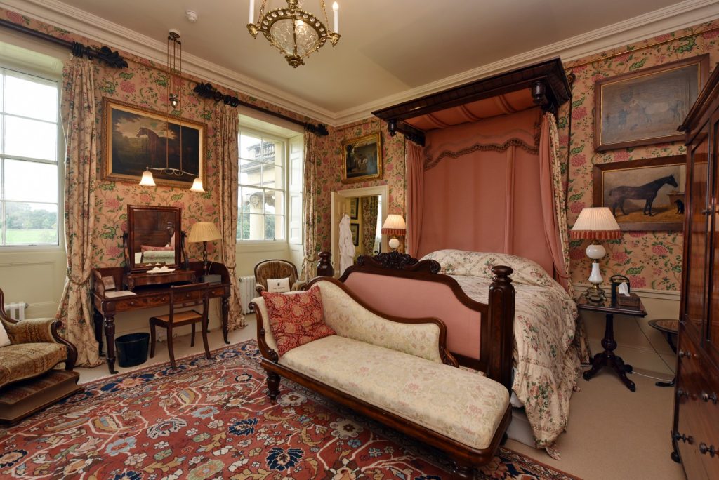 a living room filled with furniture and a bed in a bedroom
