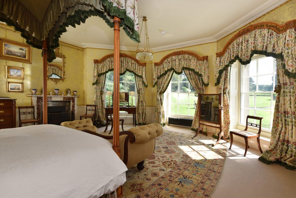 a bedroom with a large bed in a room