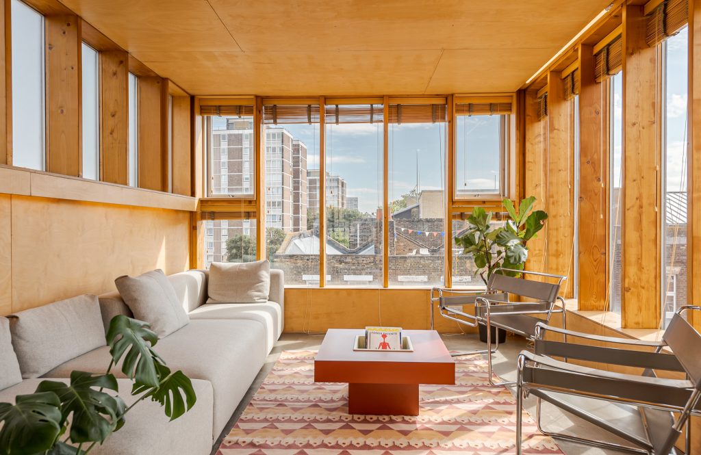 a living room filled with furniture and a large window