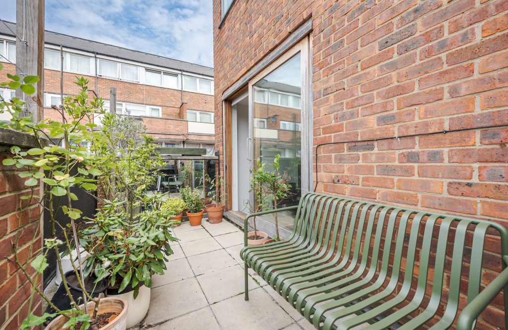 a bench in front of a brick building