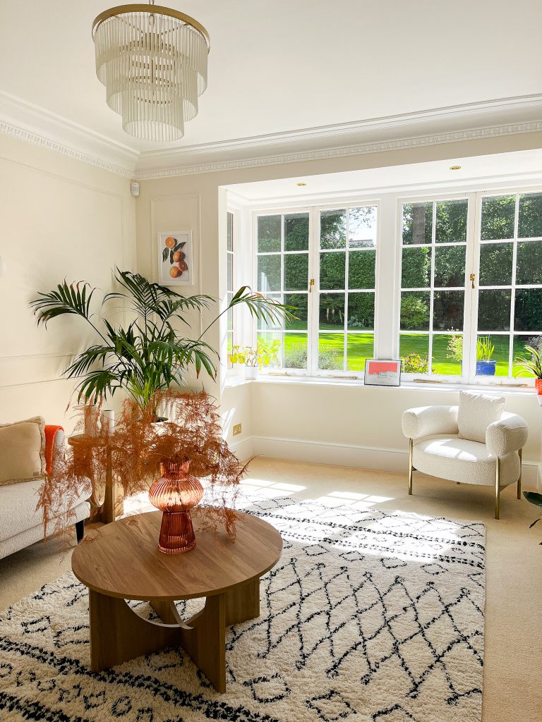 a living room filled with furniture and a large window
