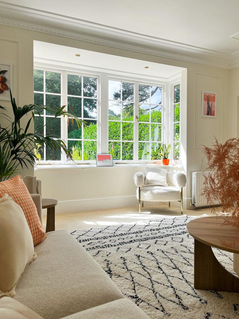 a living room filled with furniture and a large window