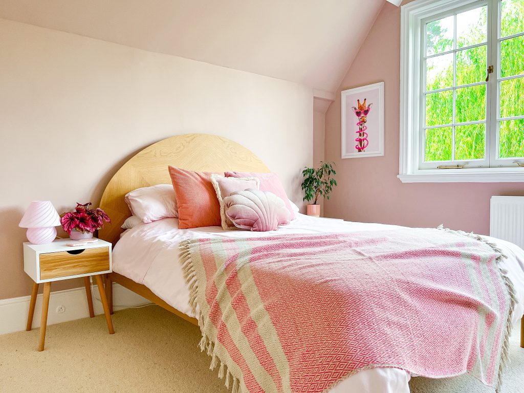 a bedroom with a bed and a chair in a room