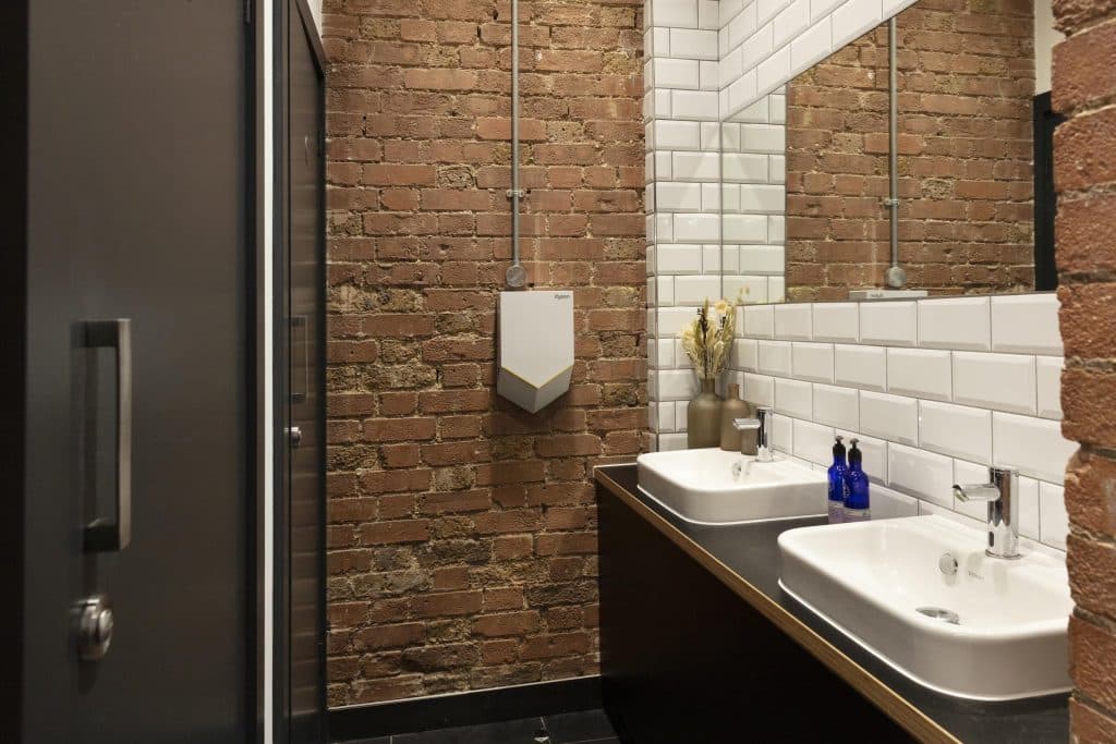 a large brick building with a sink and a mirror