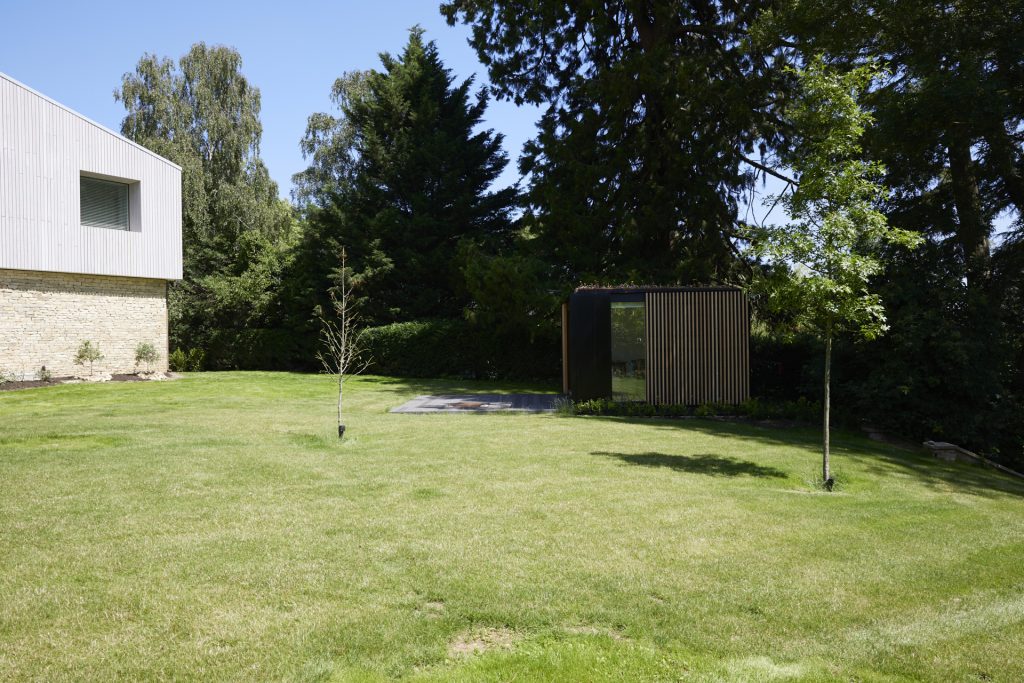 a large green field with trees in the back yard