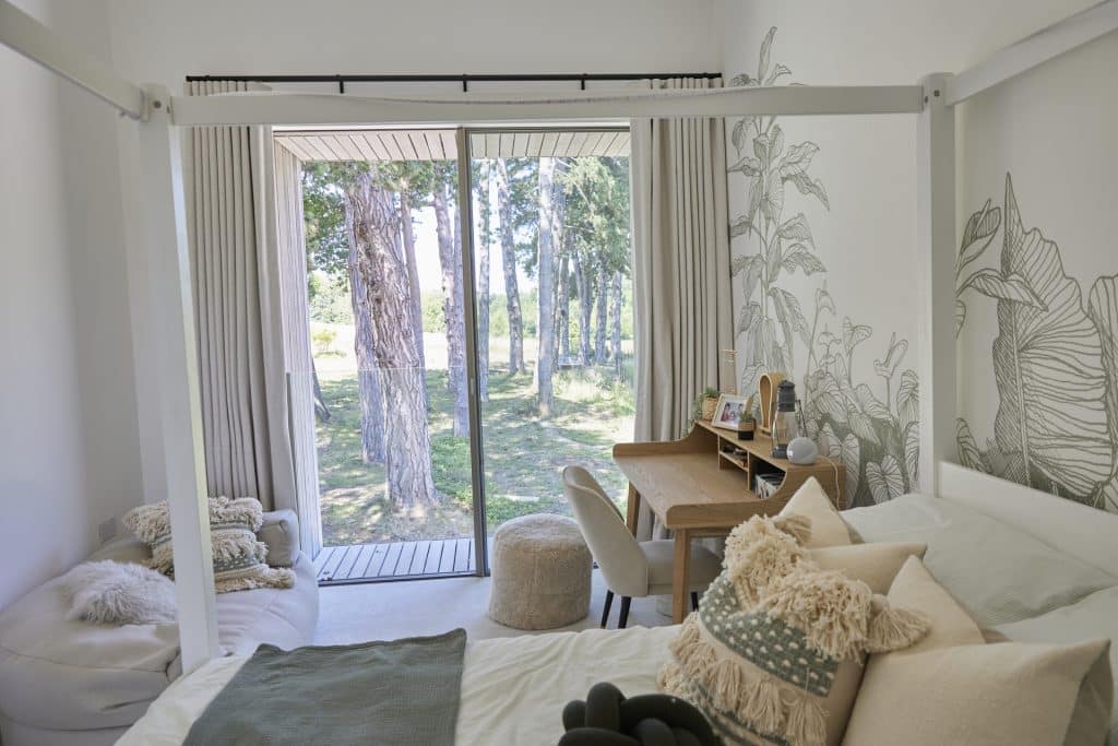 a living room filled with furniture and a large window