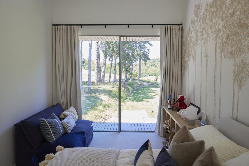 a view of a living room with a bed and a window