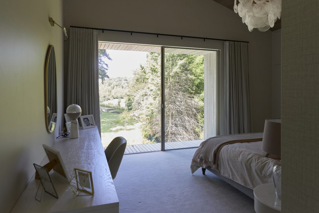a bedroom with a bed and a large window