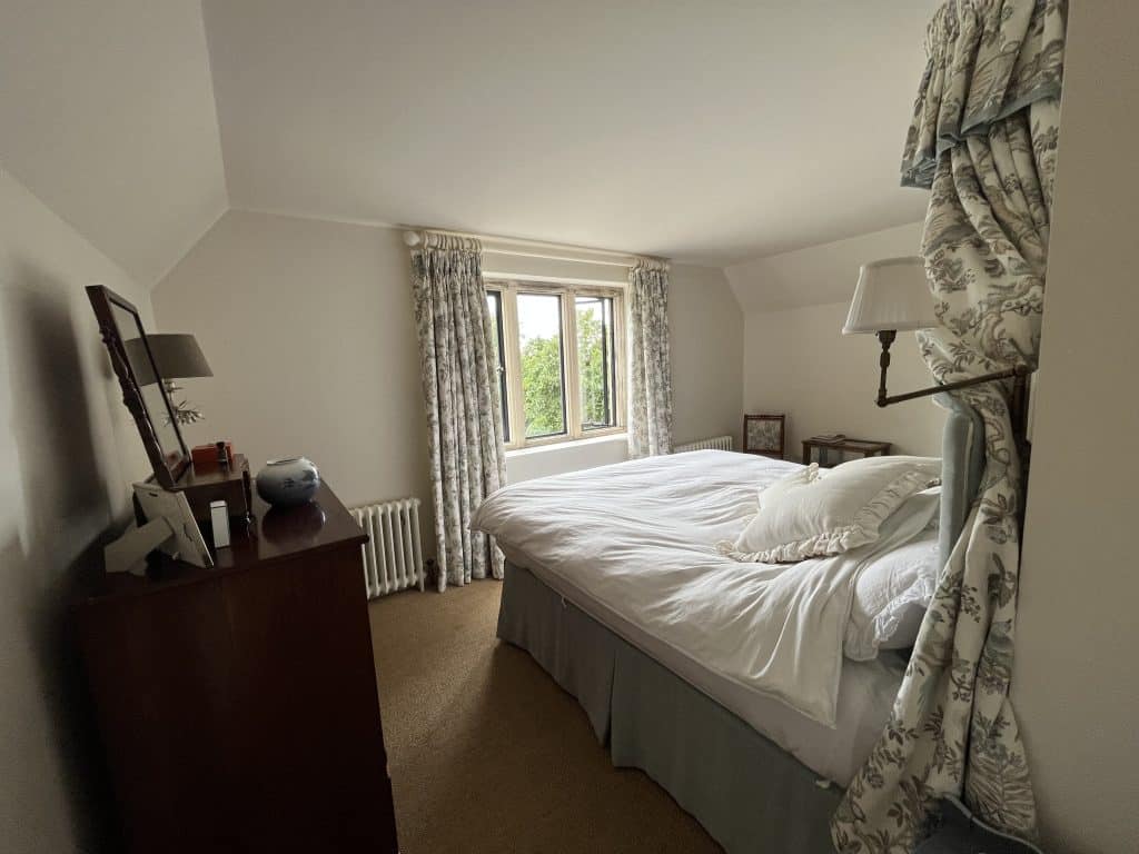a bedroom with a bed and a mirror