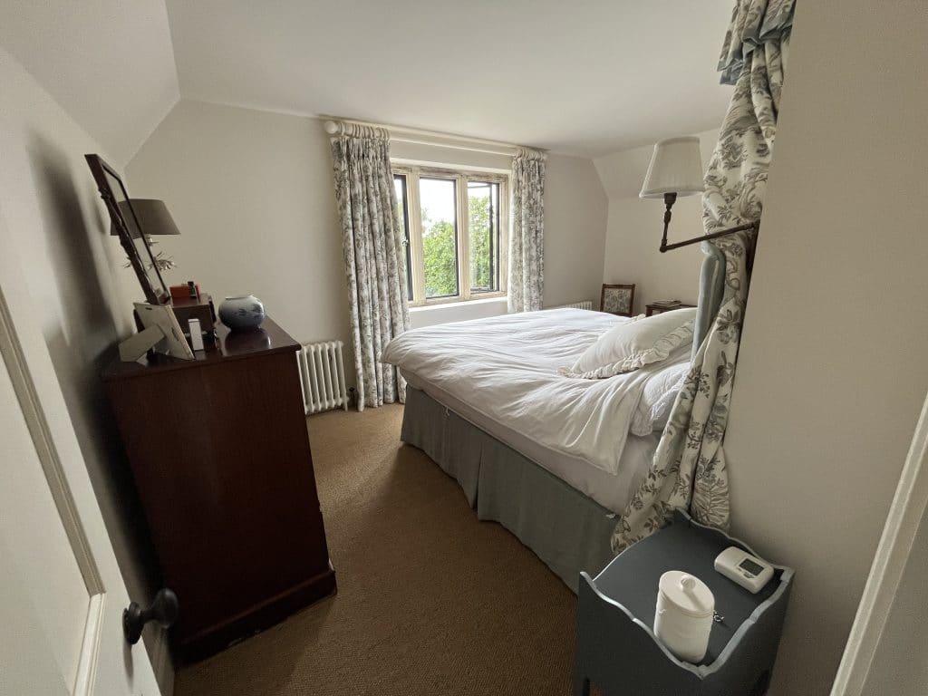 a bedroom with a bed and a mirror