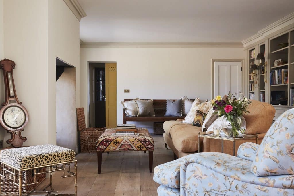 a living room with a bed and chair