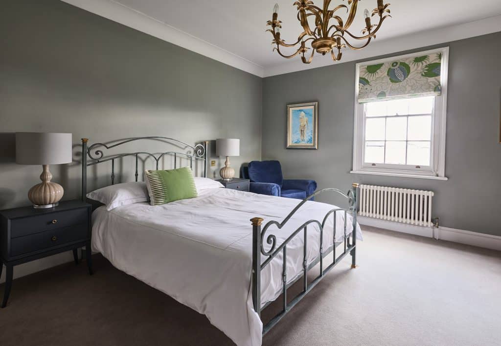 a bedroom with a bed and desk in a room
