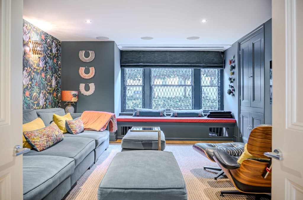 a living room filled with furniture and a flat screen tv