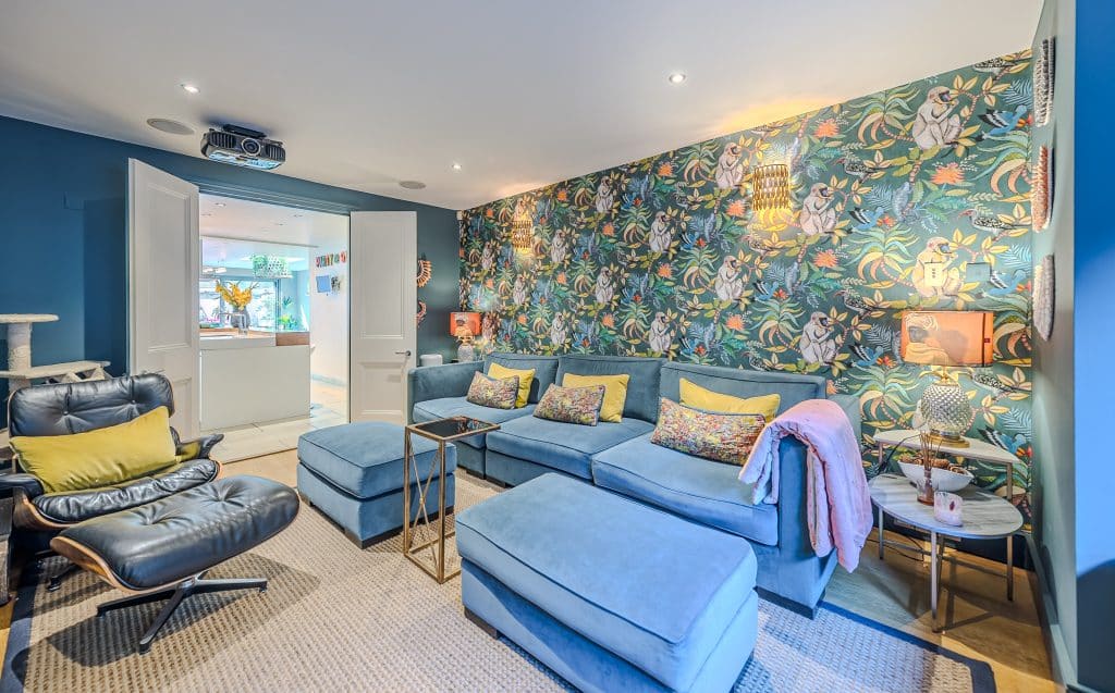 a living room filled with furniture and a painting on the wall