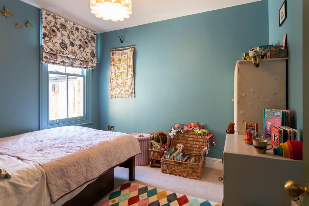 a bedroom with a bed and desk in a room