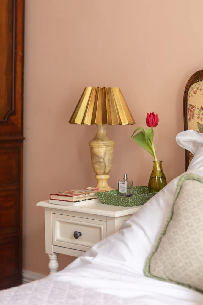 a bedroom with a bed and a mirror
