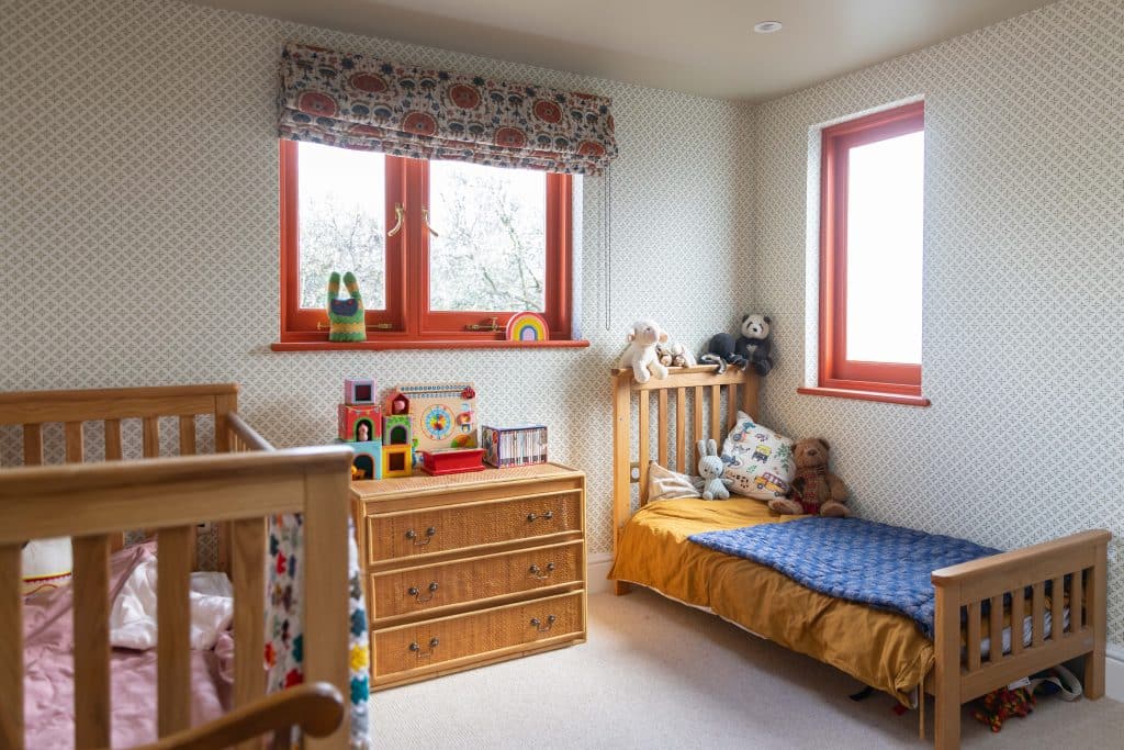 a bedroom with a bed and a chair in a room