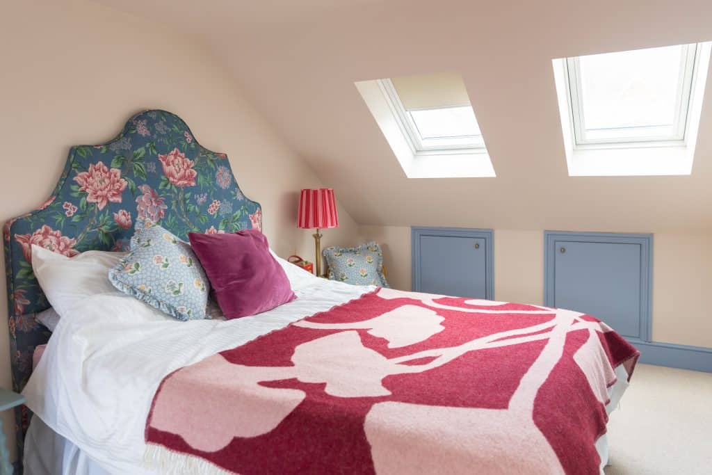 a room that has a blanket on a bed