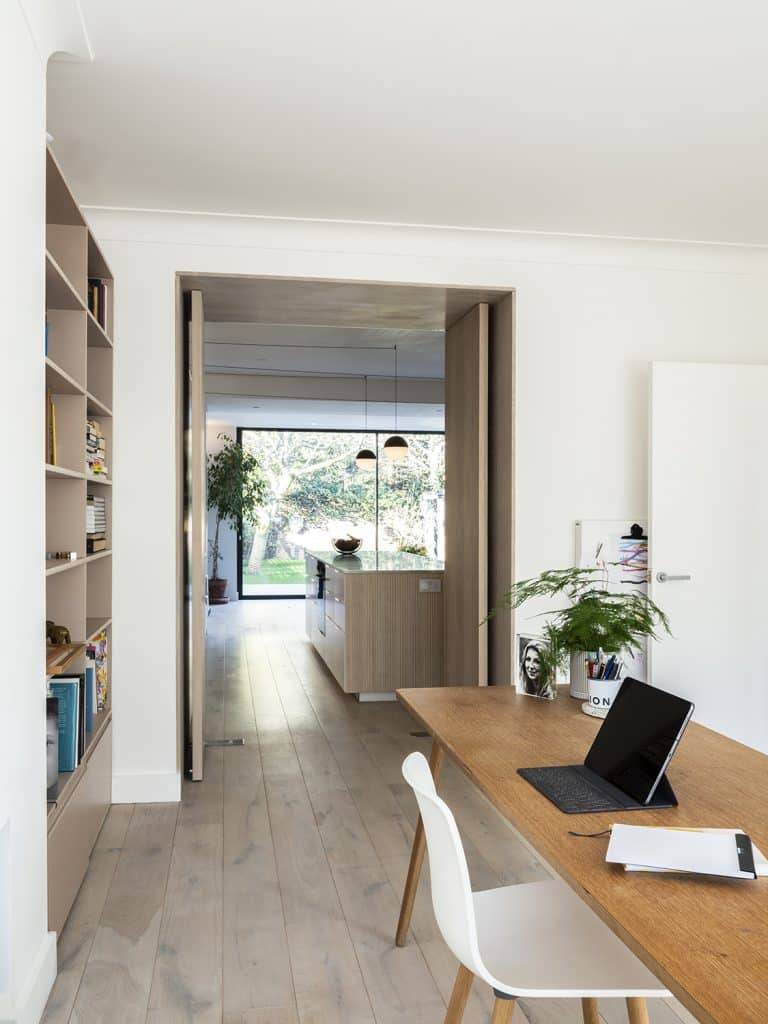 a view of a living room filled with furniture and a large window