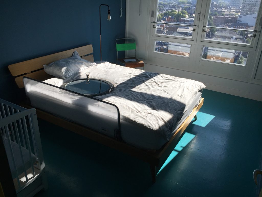 a bedroom with a bed and a window