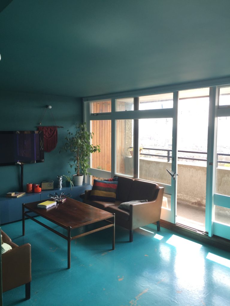 a living room filled with furniture and a large window