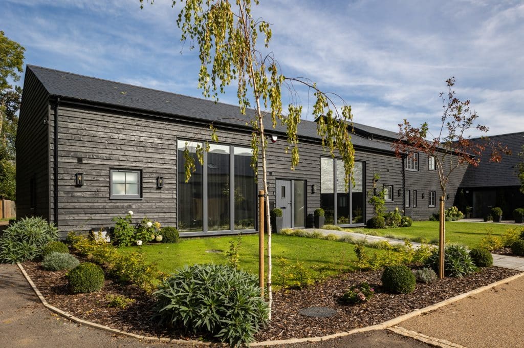 a house with bushes in front of a building