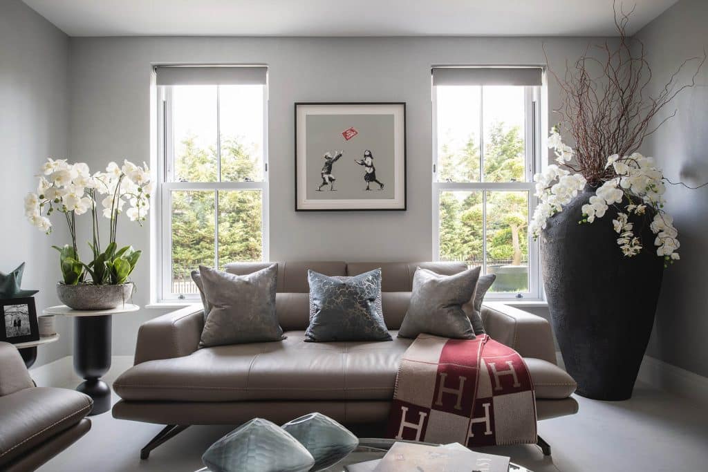 a living room filled with furniture and a large window