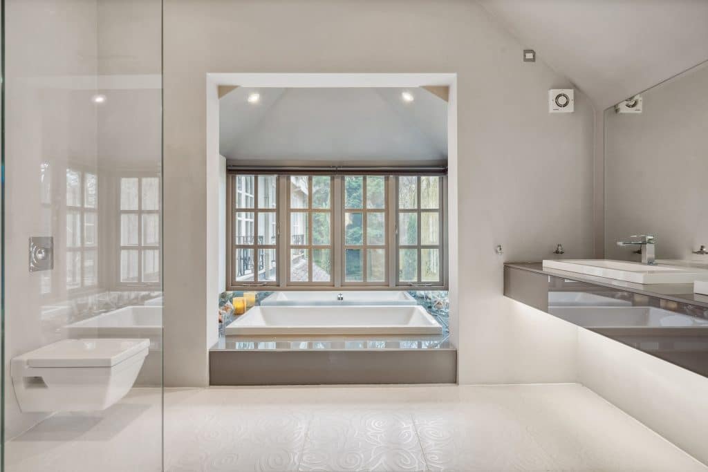 a large tub next to a window