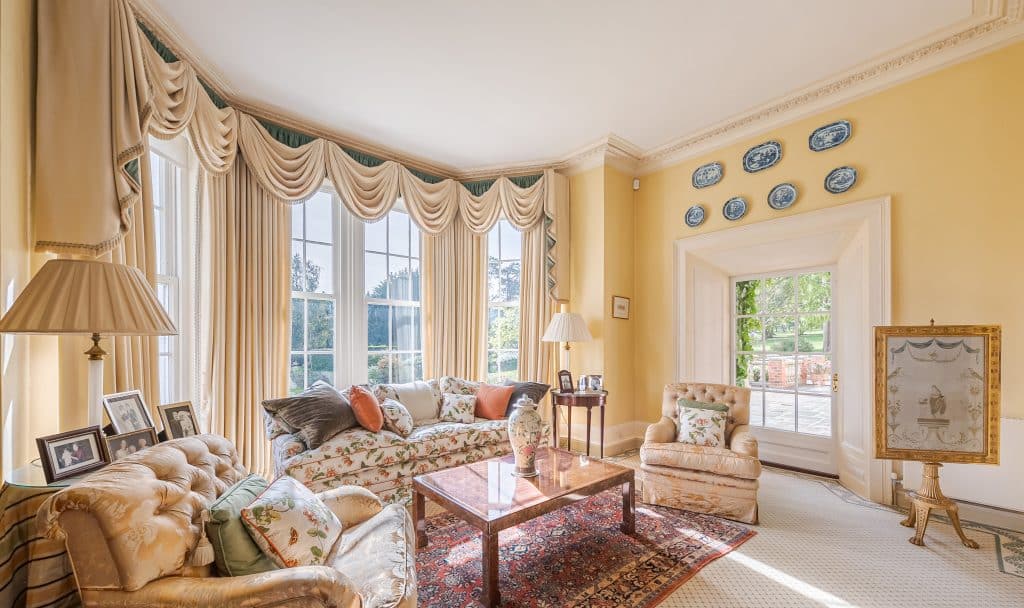 a living room filled with furniture and a large window