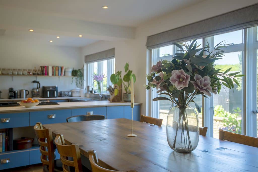 a dining room table in front of a window