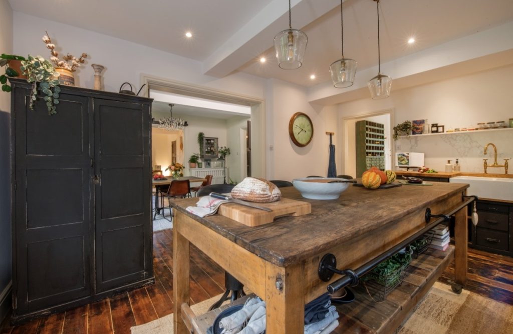 a kitchen with wooden cabinets and a fireplace