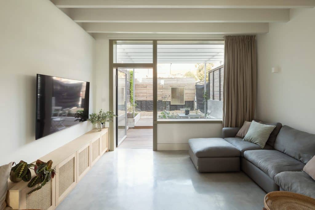 a living room filled with furniture and a large window